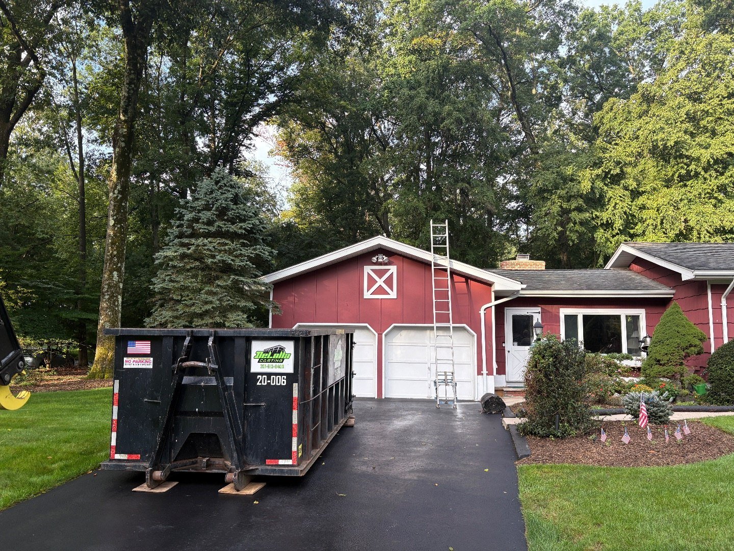 DeLalla Carting dumpster on a driveway in Bergen County