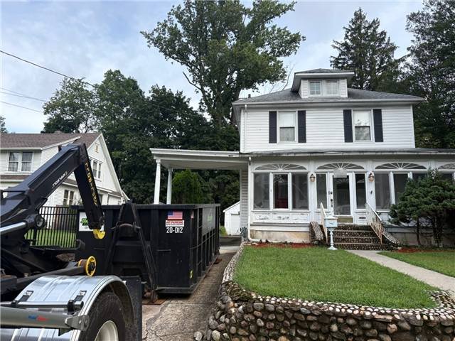 20-yard dumpster being set in a Hillsdale, NJ driveway