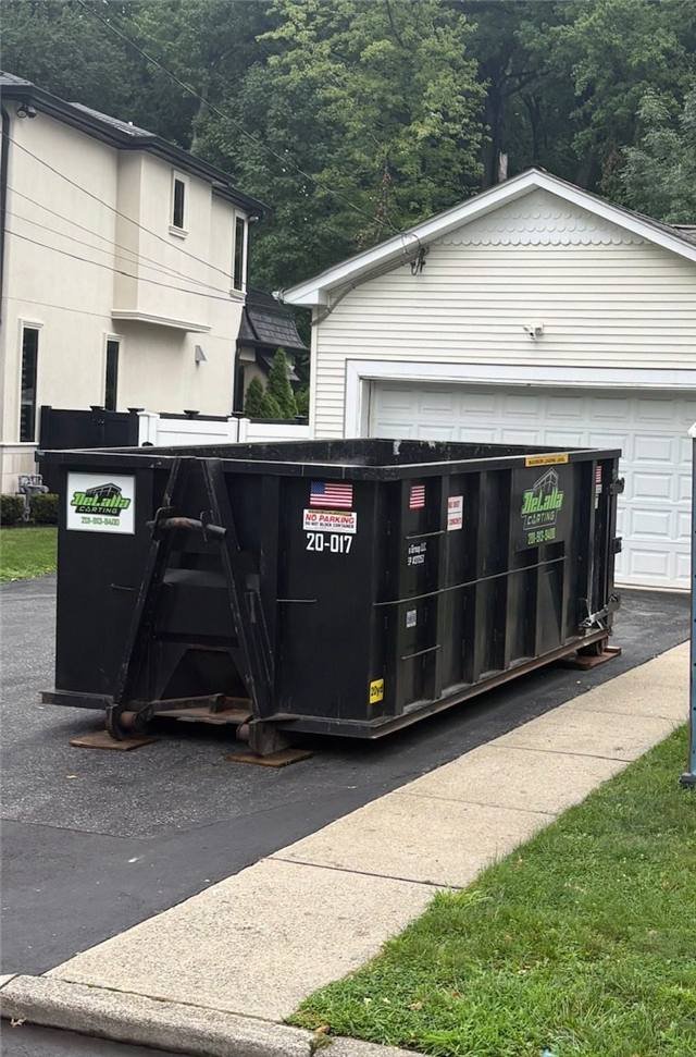 Loaded 20-yard dumpster on a gravel driveway in Paramus, NJ
