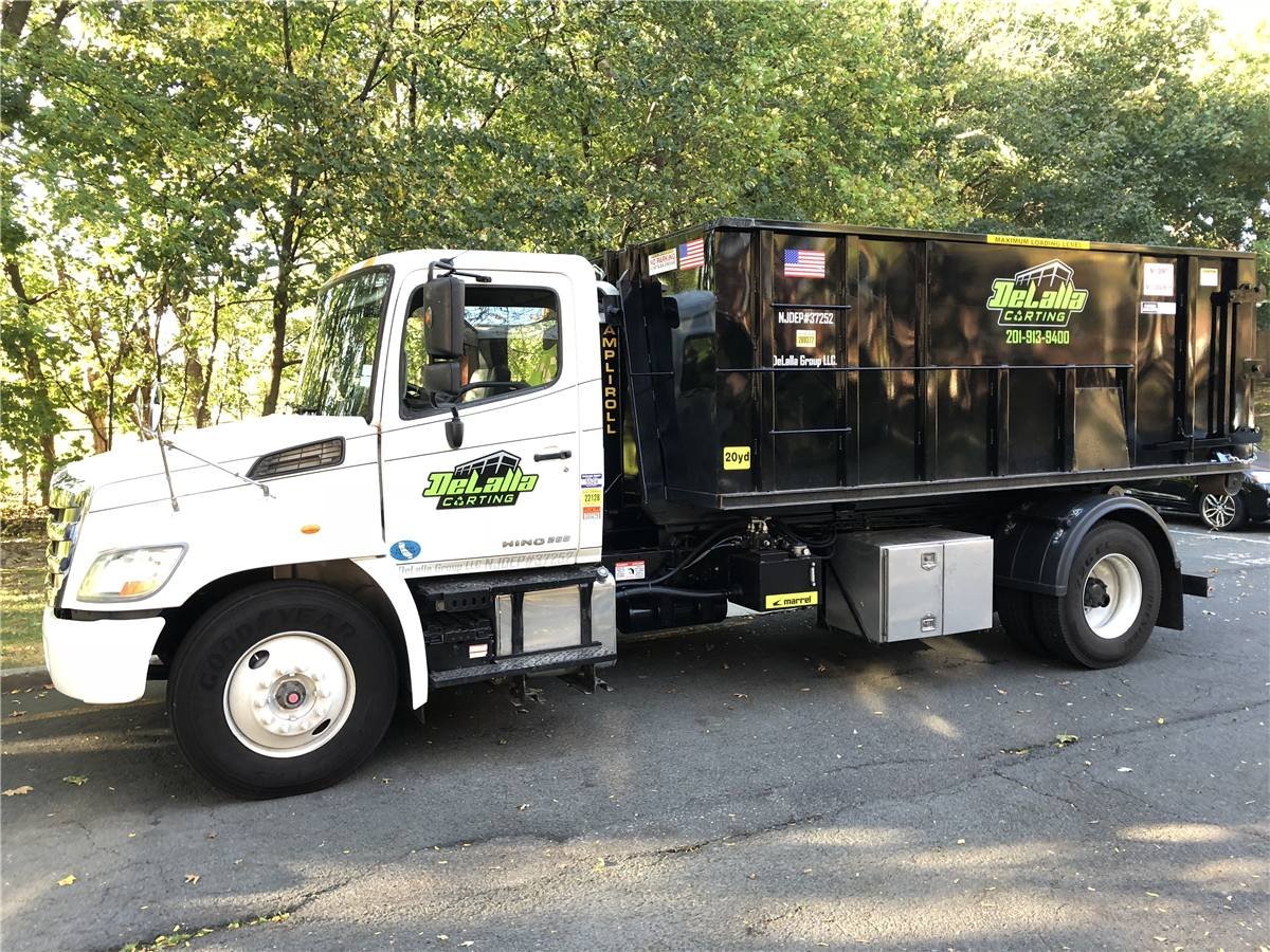 DeLalla Carting roll-off truck delivering a 20-yard container